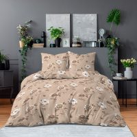 Double bed with floral bedding and dark blankets standing in grey bedroom interior with fresh plants, paintings and lamp
